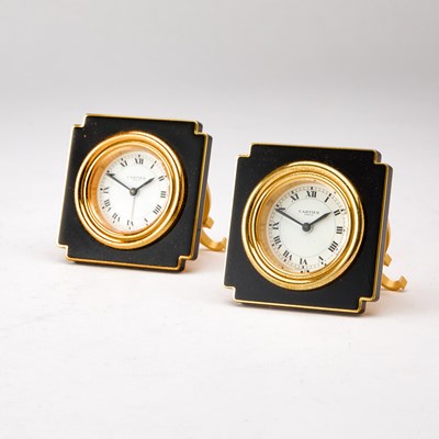 Lot 203 - Two Cartier Gilt-Metal and Black Enamel Travel Clocks