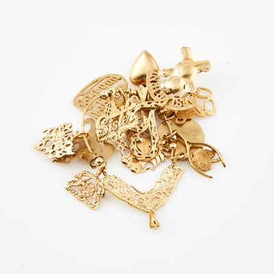Lot 287 - Gold Charm Holder with 14 charms, 14K 9 dwt.