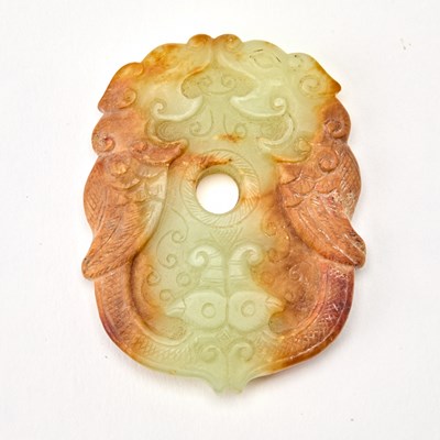 Lot 66 - A Chinese Carved Celadon and Russet Jade Pendant