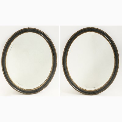 Lot 172 - Pair of Irish Parcel Gilt and Ebonized Wood Oval Mirrors