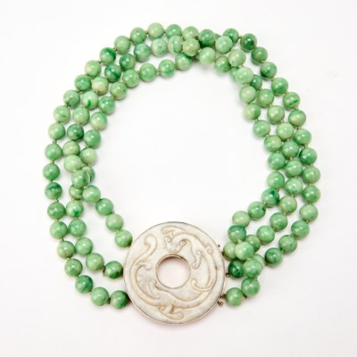 Lot 30 - A Chinese Jadeite-Bead Necklace with a Carved White Jade Bi Pendant