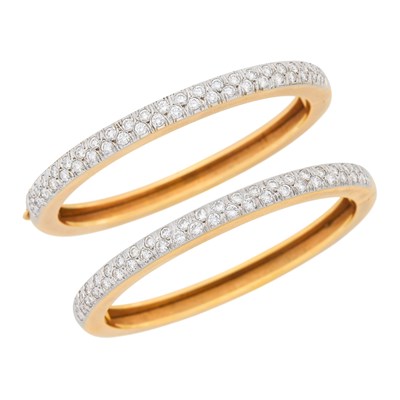 Lot 104 - Pair of Two-Color Gold and Diamond Bangle Bracelets