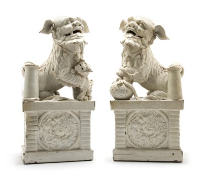 Lot 2224 - Pair of Chinese White Glazed Pottery Foo Lions...