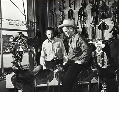 Lot 24 - ROTHSTEIN, ARTHUR Cowboy trying a saddle at...